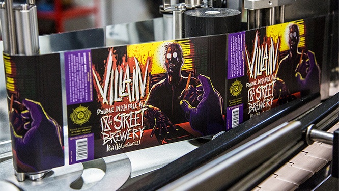 villain beer labels on automated label application machinery