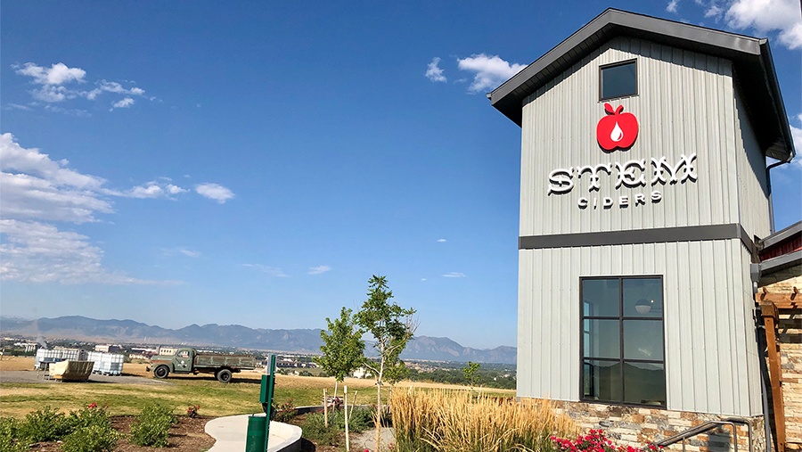 outside garden view of steel stem ciders facility overlooking a field on a sunny day with blue skies