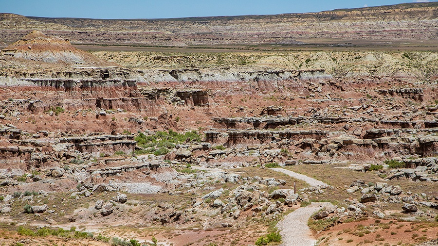 gravel path winding through a treacherous rocky desert terrain