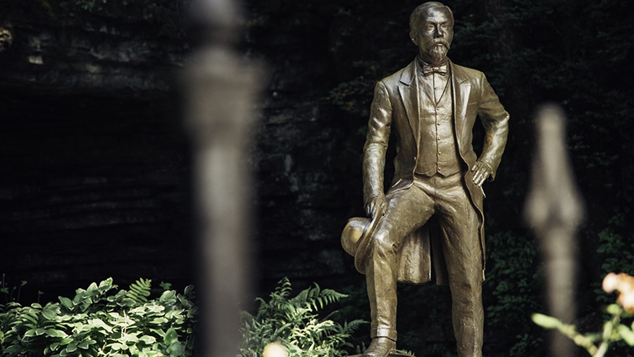 statue of Jack Daniel near a limestone cavern