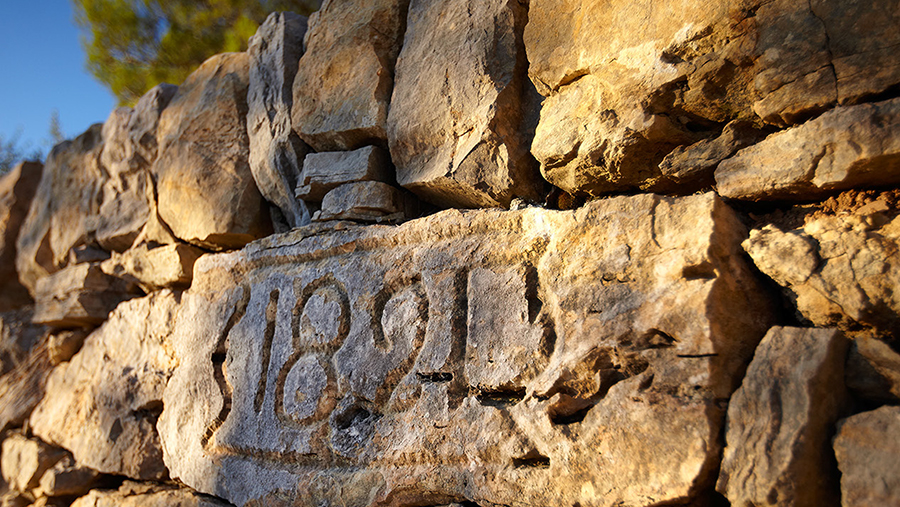 Stone wall with a dated stone inscribed 1821