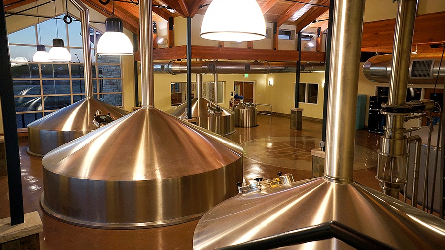 room of stainless steel tanks and equipment used to brew beer