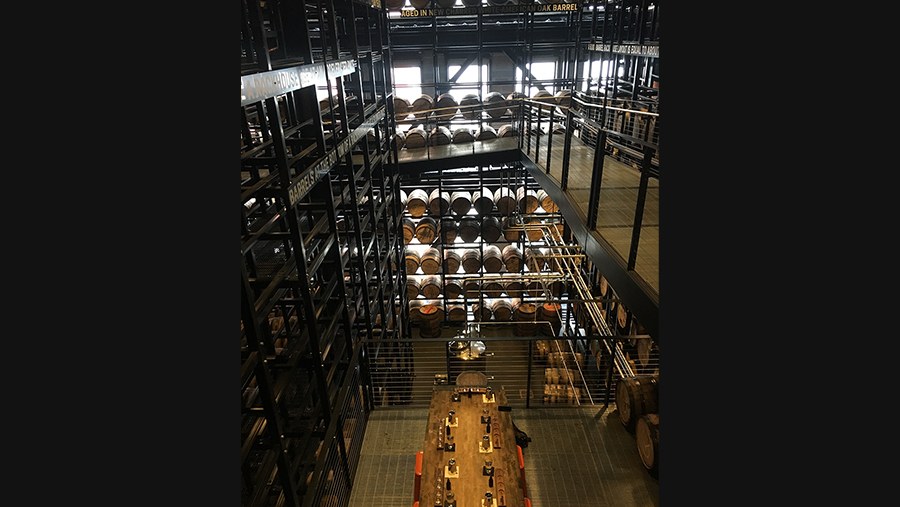 multi-level steel rackhouse completely filled with full whiskey barrels