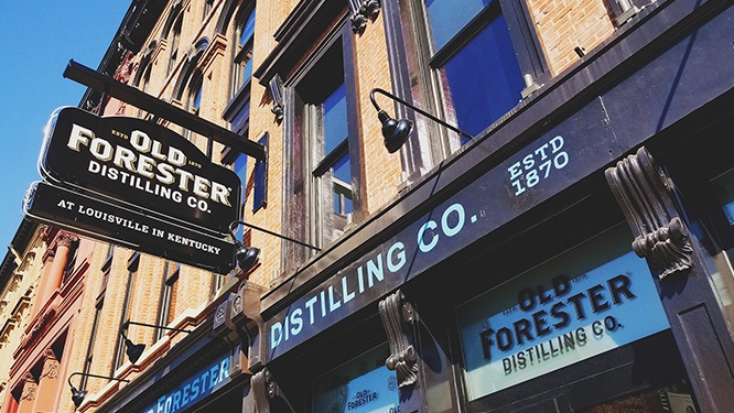 old forester sign hangs over the distillery's main street entrance