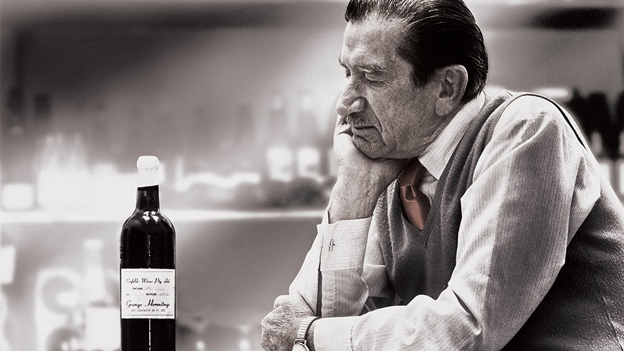 Penfold's original chief winemaker, Max Schubert, ganders at a bottle of his signature Grange wine