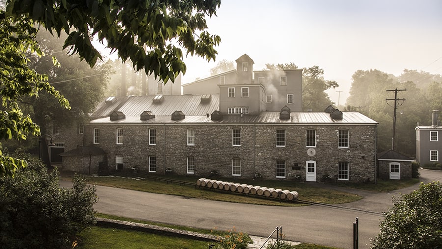 Woodford Reserve distillery on a foggy morning surrounded by trees